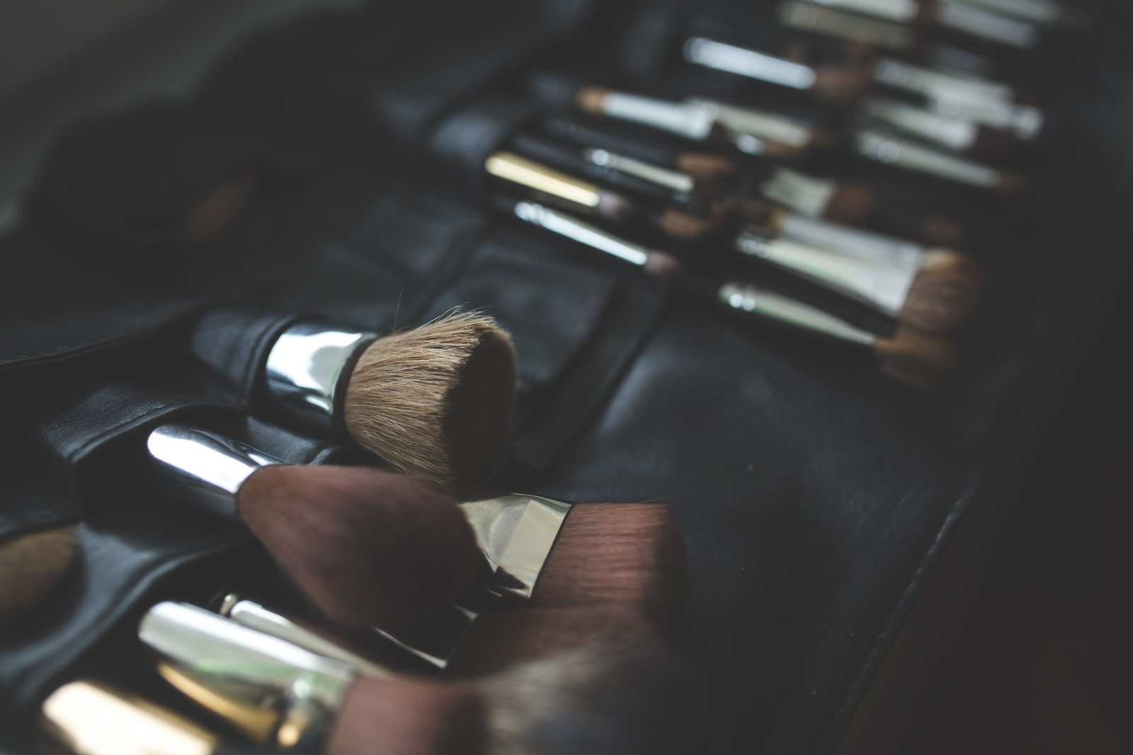 A stylish arrangement of makeup brushes highlights the product selection process behind bridal makeup essentials.