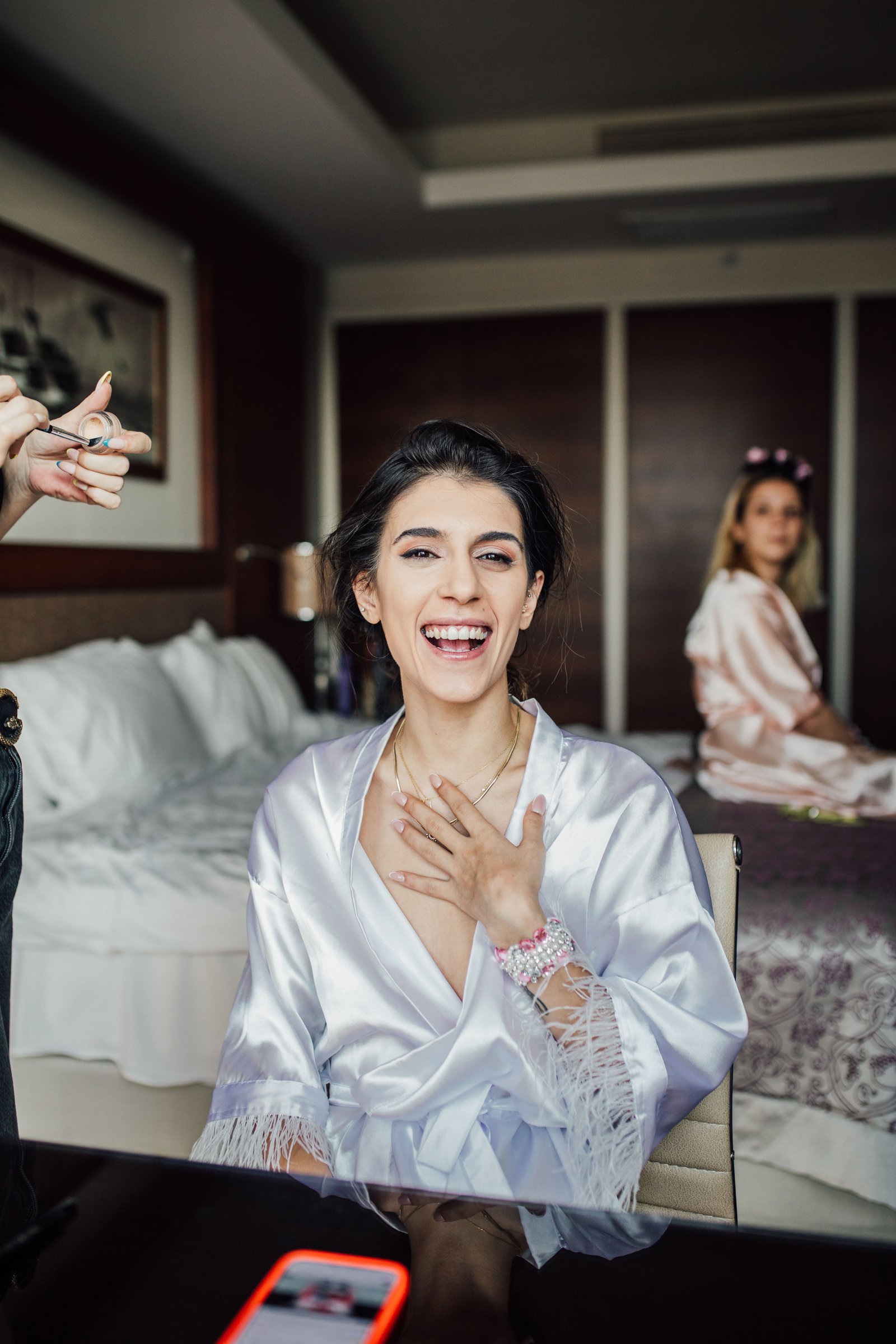 An on-location hair and makeup team styles a bridal party, an alternative many brides compare against a bridal beauty salon.