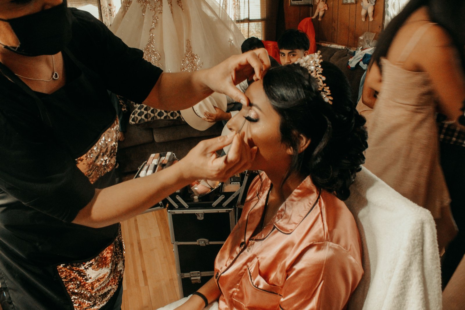 A makeup artist applies the finishing touches during the final stage of a bridal hair and makeup timeline.