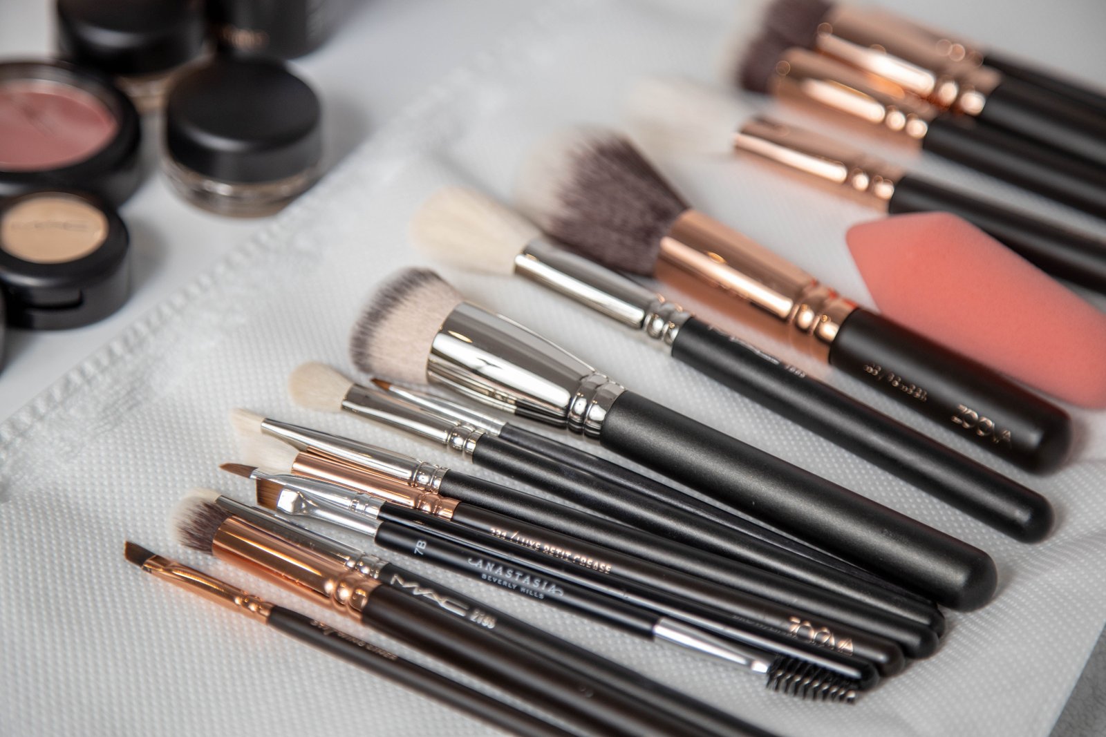 A bridal touch-up kit laid out with essentials for the wedding day beauty checklist.