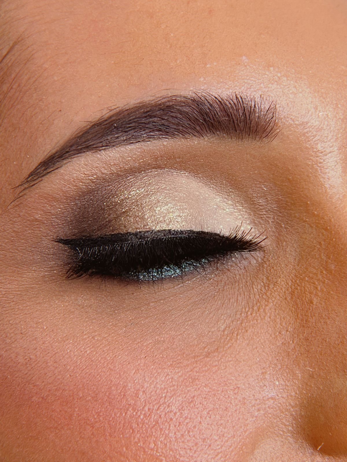 A bride with bridal glitter eye makeup applied for her wedding day look.
