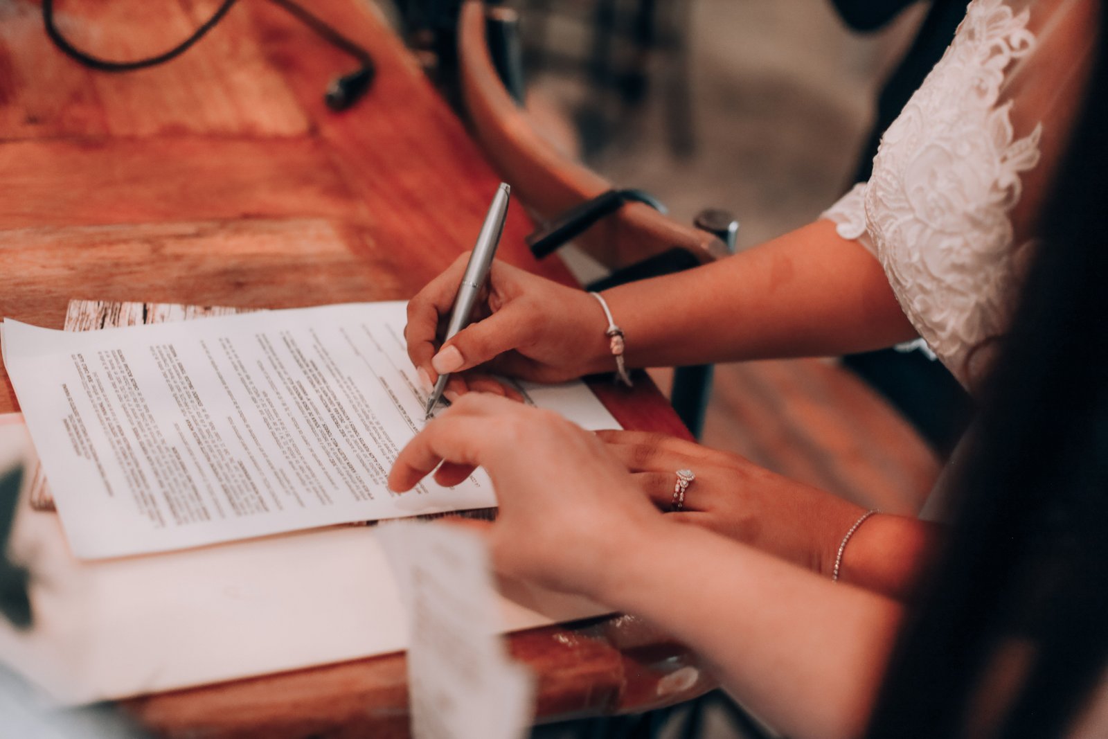 A bride reviews and signs a written contract, a step that helps avoid common bridal makeup artist red flags.