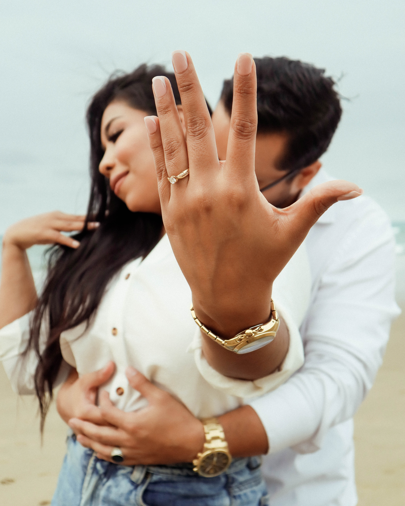 A newly engaged couple embraces outdoors, marking the start of wedding beauty planning for the bride-to-be.