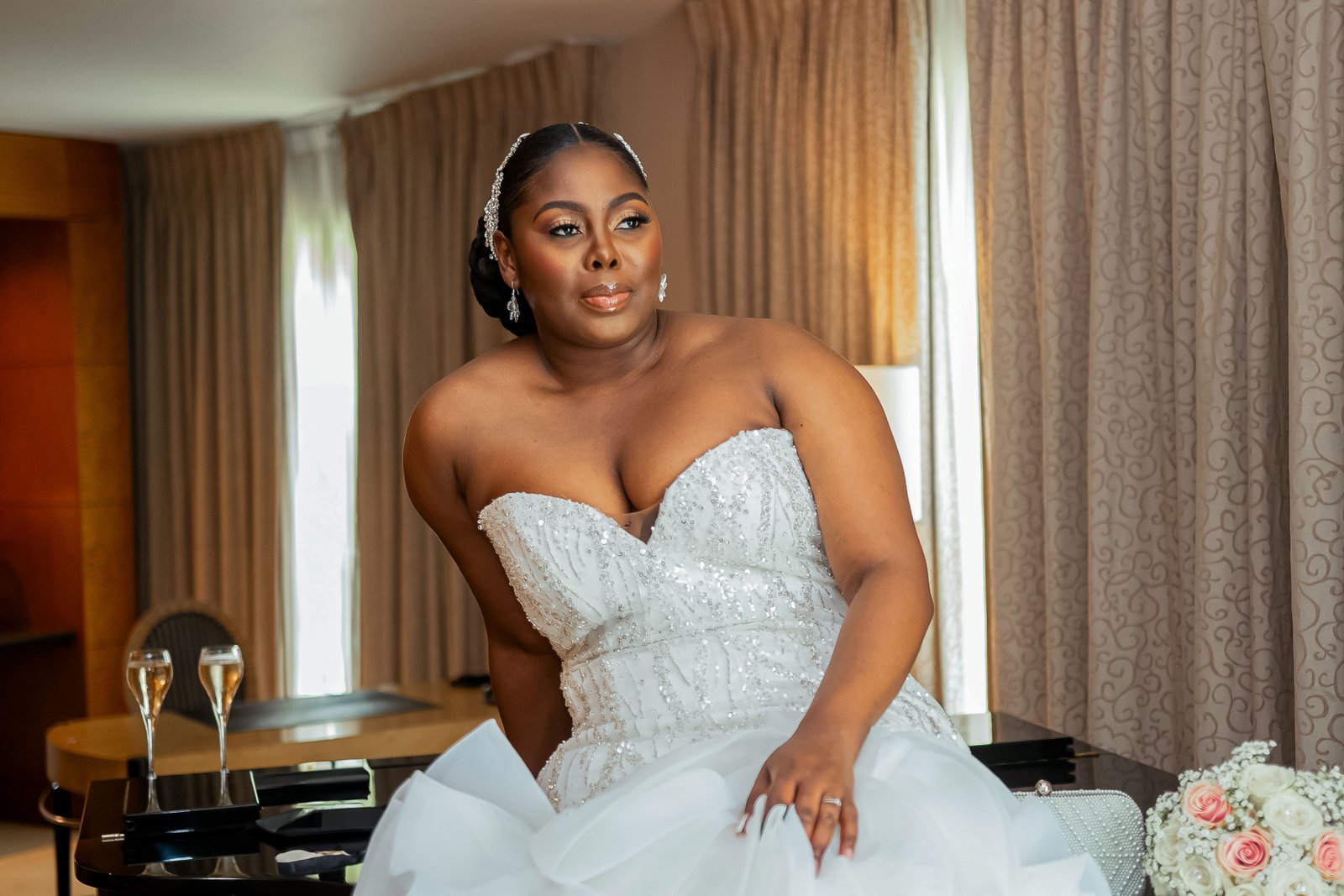 A Black bride wears a stunning wedding hairstyle for her portrait, showcasing natural texture and detail.