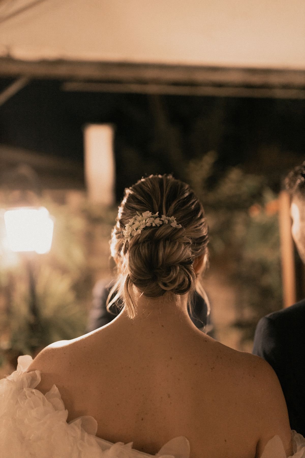 Several bridesmaids wearing coordinated bridesmaid updo hairstyles at an outdoor wedding.