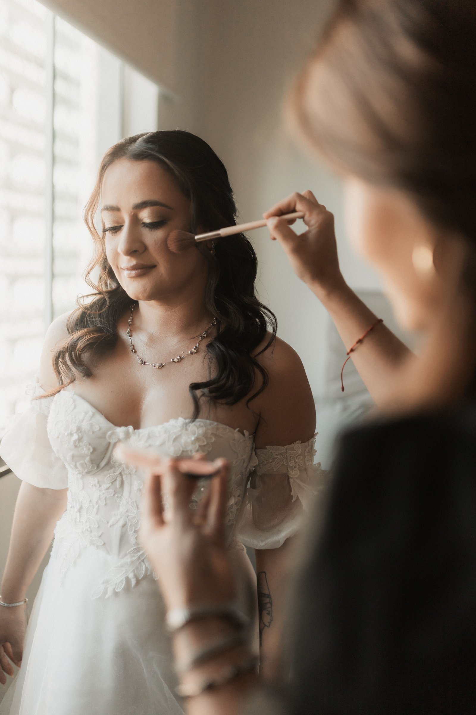 A bride wears a natural, simplified makeup look, an example of affordable wedding hair and makeup done well.