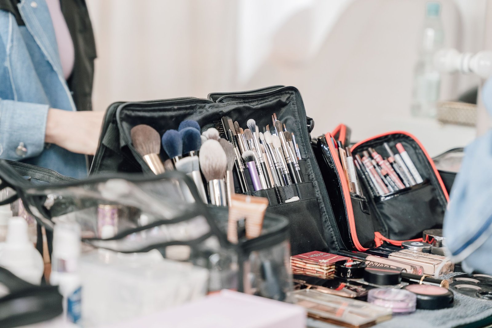 A traveling hair and makeup artist portable kit of brushes and tools arranged and ready for an on-location bridal appointment.