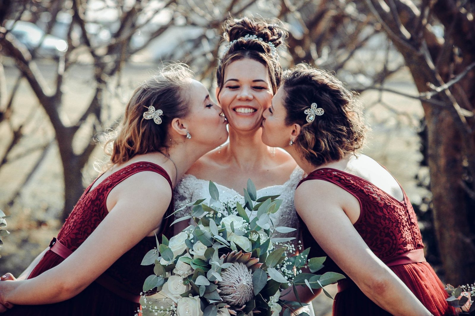 Bridesmaids wear soft, floral-accented boho bridesmaid hair for an outdoor wedding.