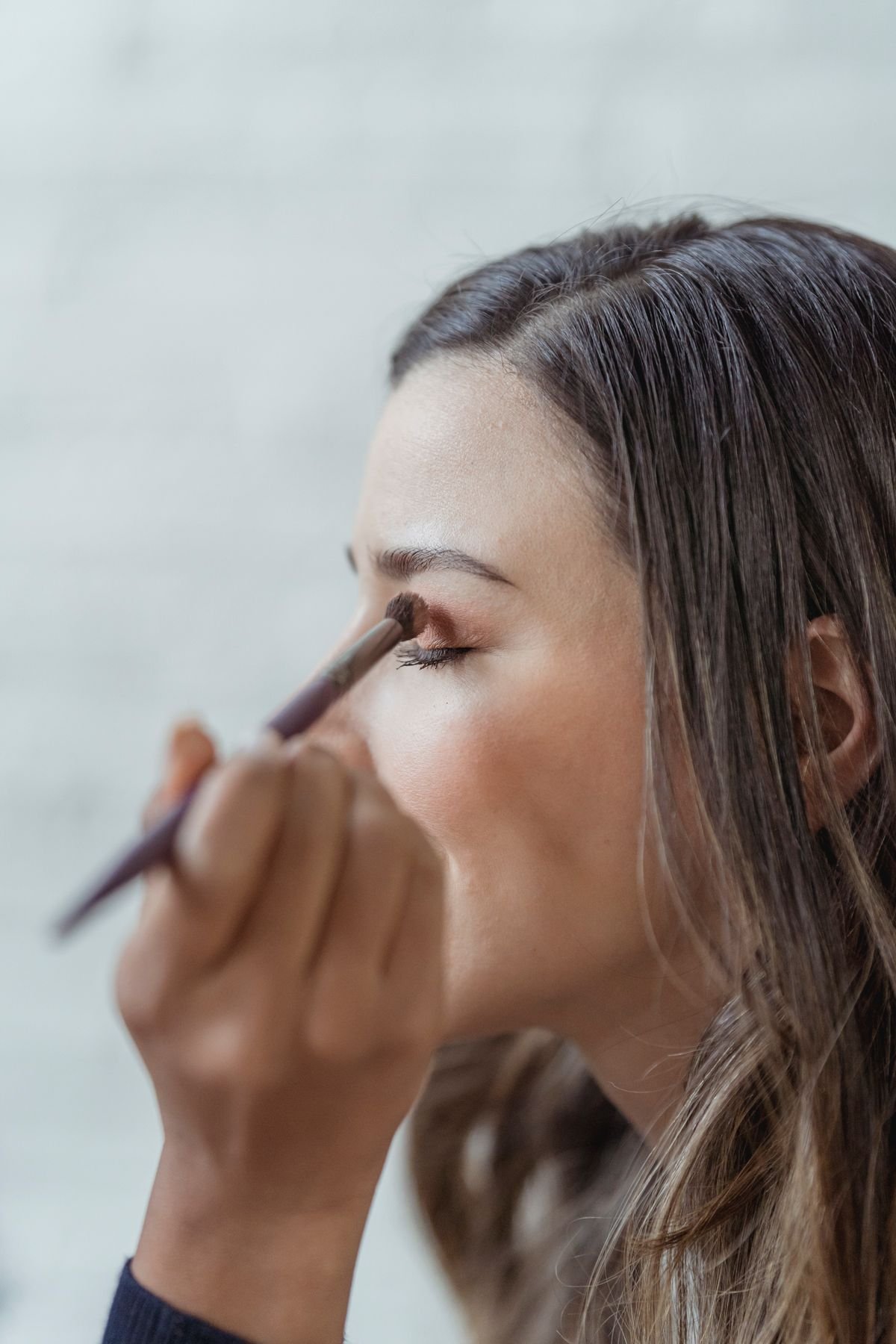 A soft neutral eyeshadow look blended with warm brown and gold tones.