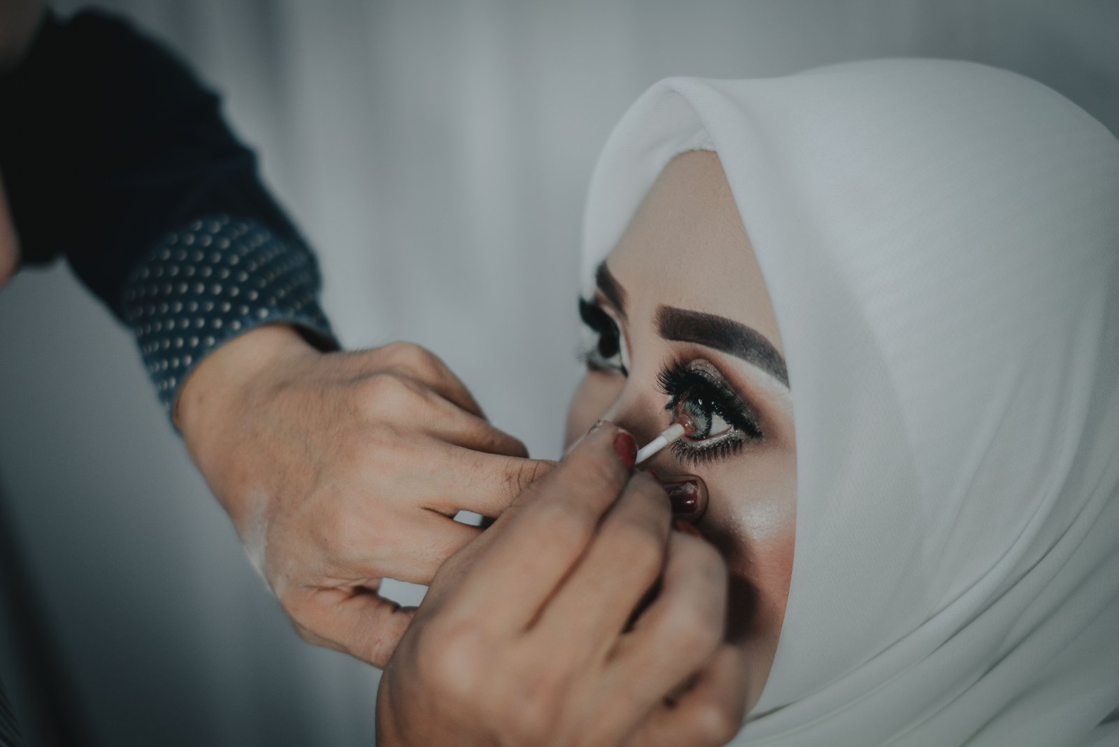Close-up of NARS Radiant Creamy Concealer being applied under the eyes for bridal makeup.