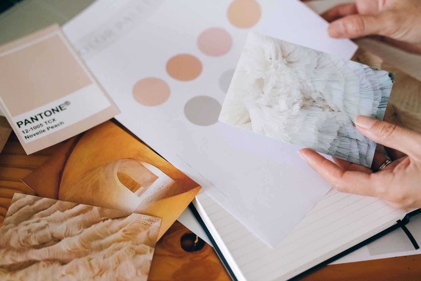 A bridal mood board with fabric swatches and color references supports early wedding beauty planning decisions.