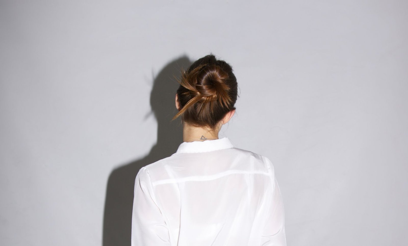 A finished easy updo shows a soft, twisted bun at the back of the head.