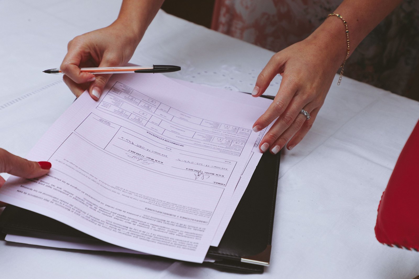 A bride reviews pricing details as part of planning her wedding beauty budget.