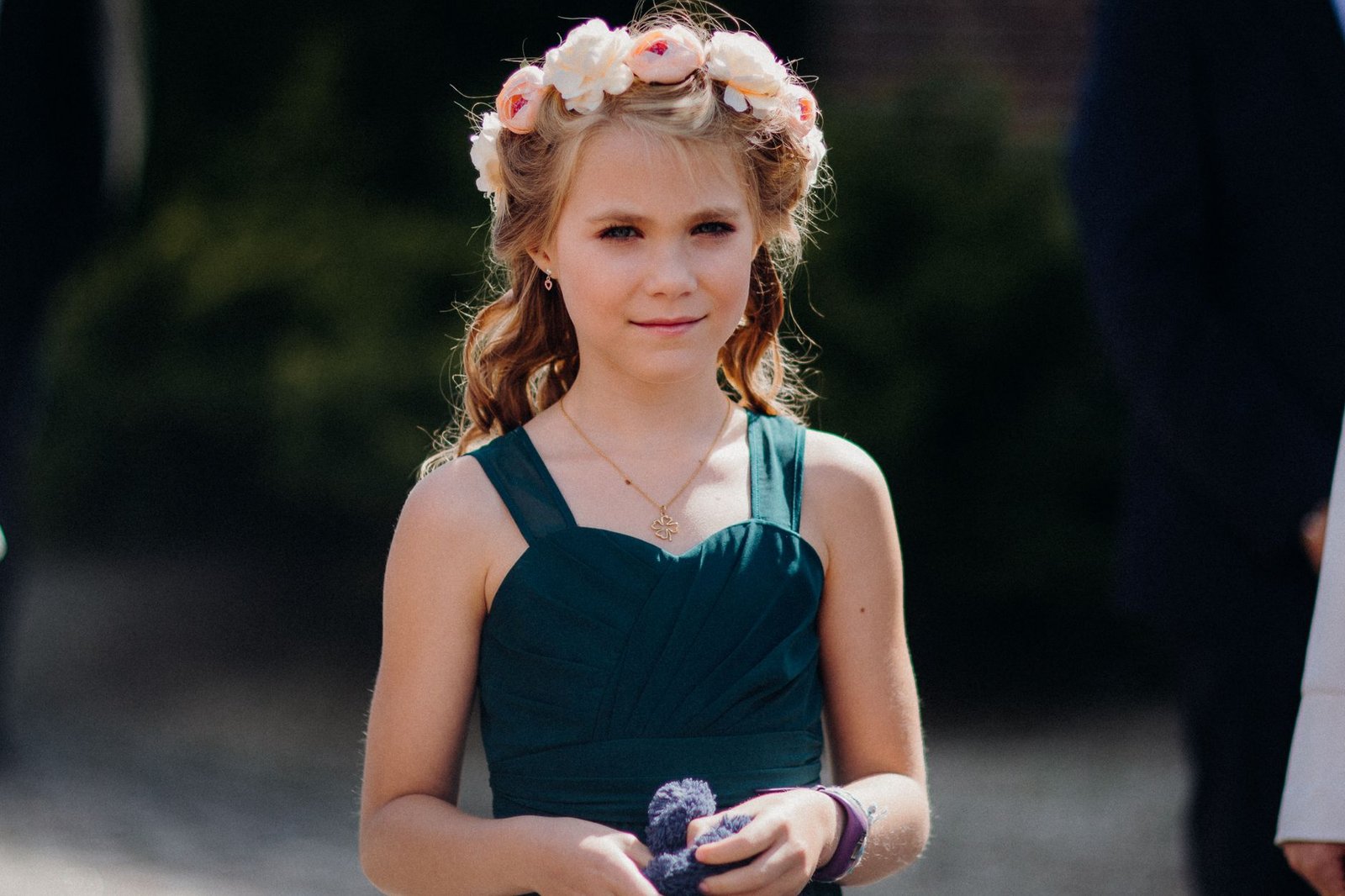 A twisted half-up maid of honor updo with soft face-framing pieces.