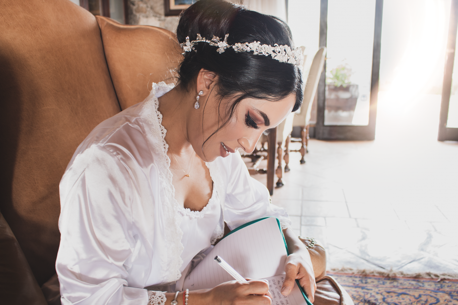 A bride works through her wedding beauty budget with a notebook and planning checklist.
