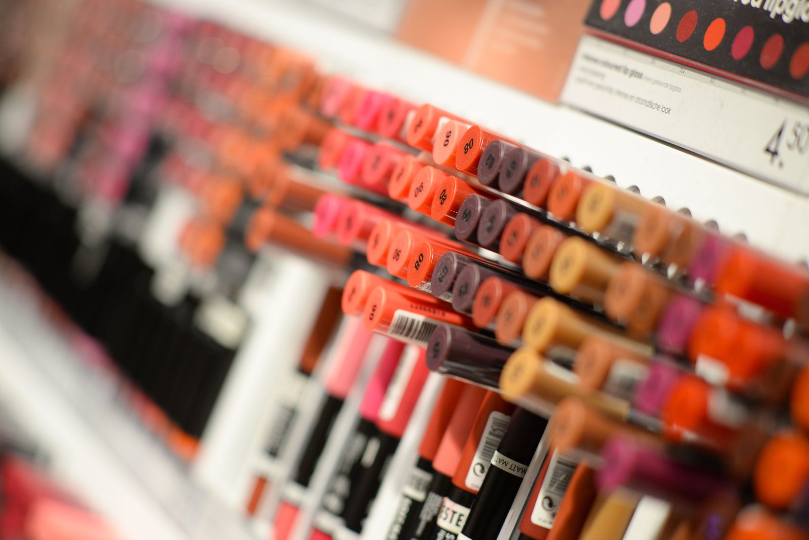 Shelves of lipstick and cosmetic shades displayed inside a beauty boutique