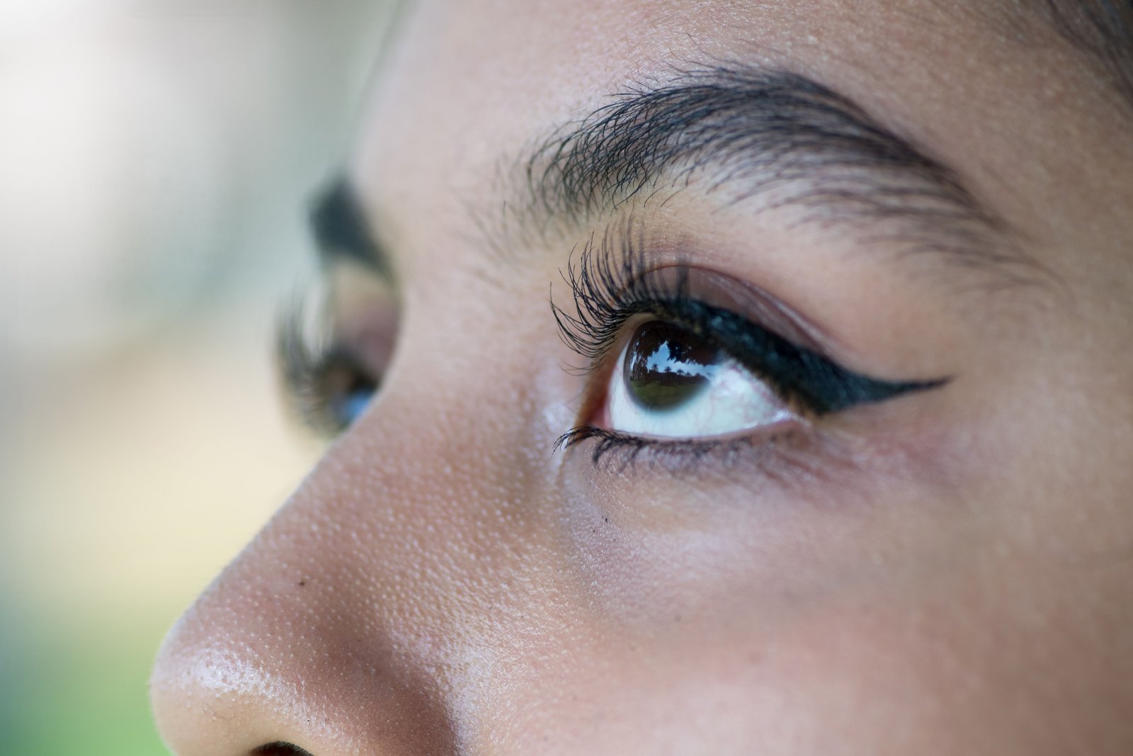 Close-up of a precision winged eyeliner look using water activated liner
