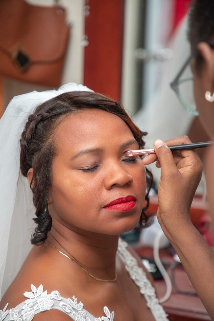 Makeup artist finishing a bride's eye makeup, an alternative to do it yourself lashes on the wedding morning