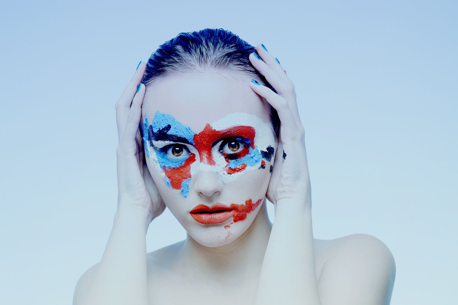 Artistic portrait featuring vibrant, professionally applied face paint