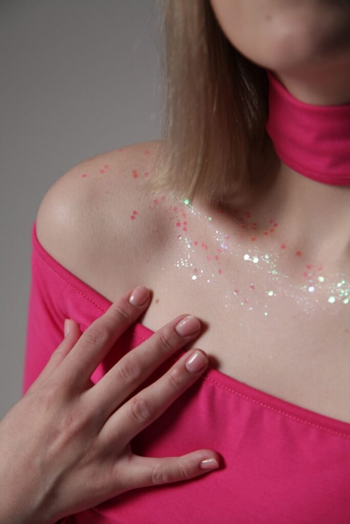 Cosmetic grade shimmer from body paints for adults applied to a shoulder for a party look