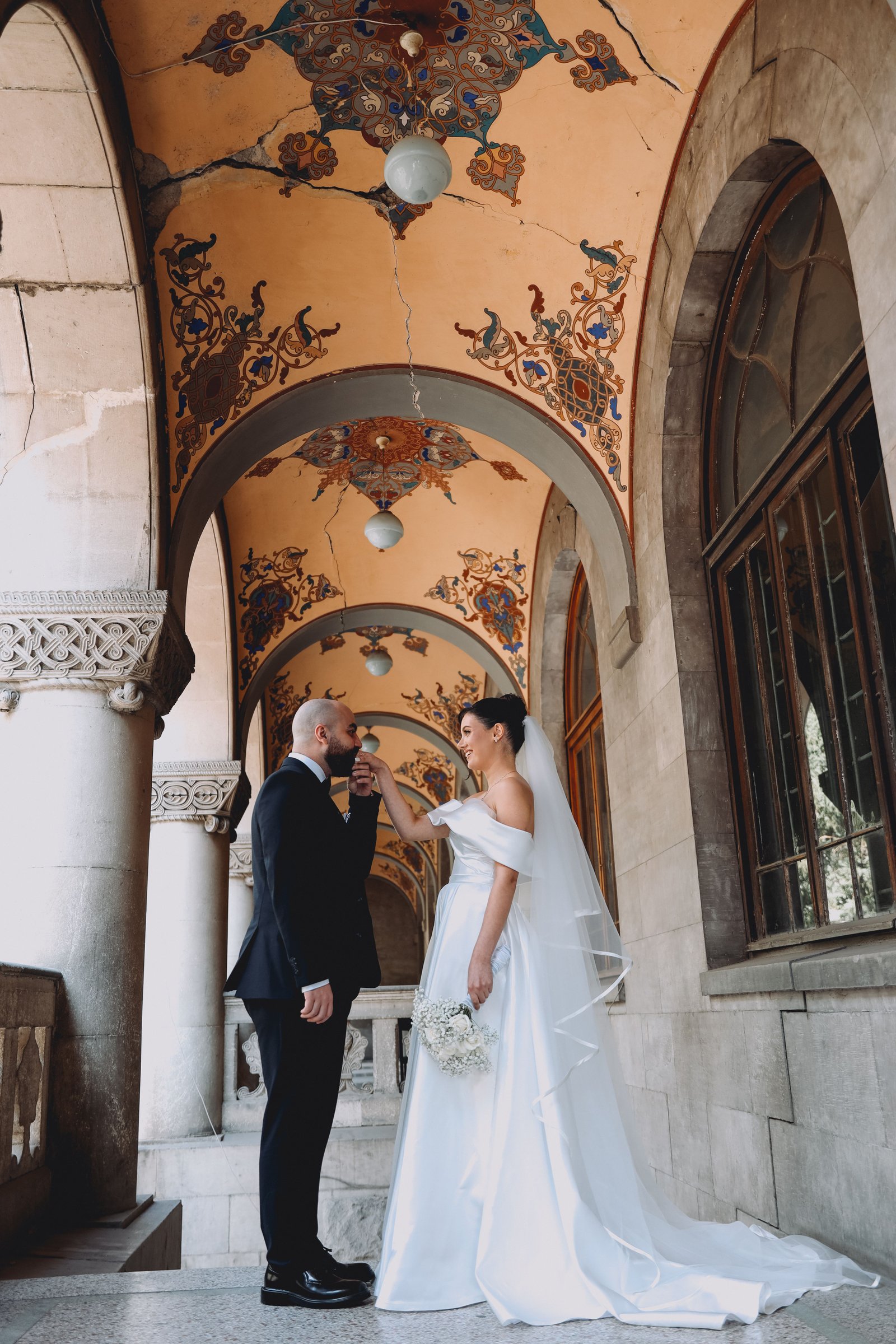 A bride poses near historic architecture and warm lighting at an Oxford Exchange wedding reception.