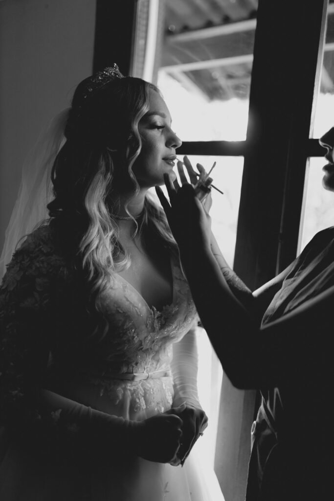 Bride having her makeup finished on her wedding morning, when secure lashes matter more than self adhesive eyelashes