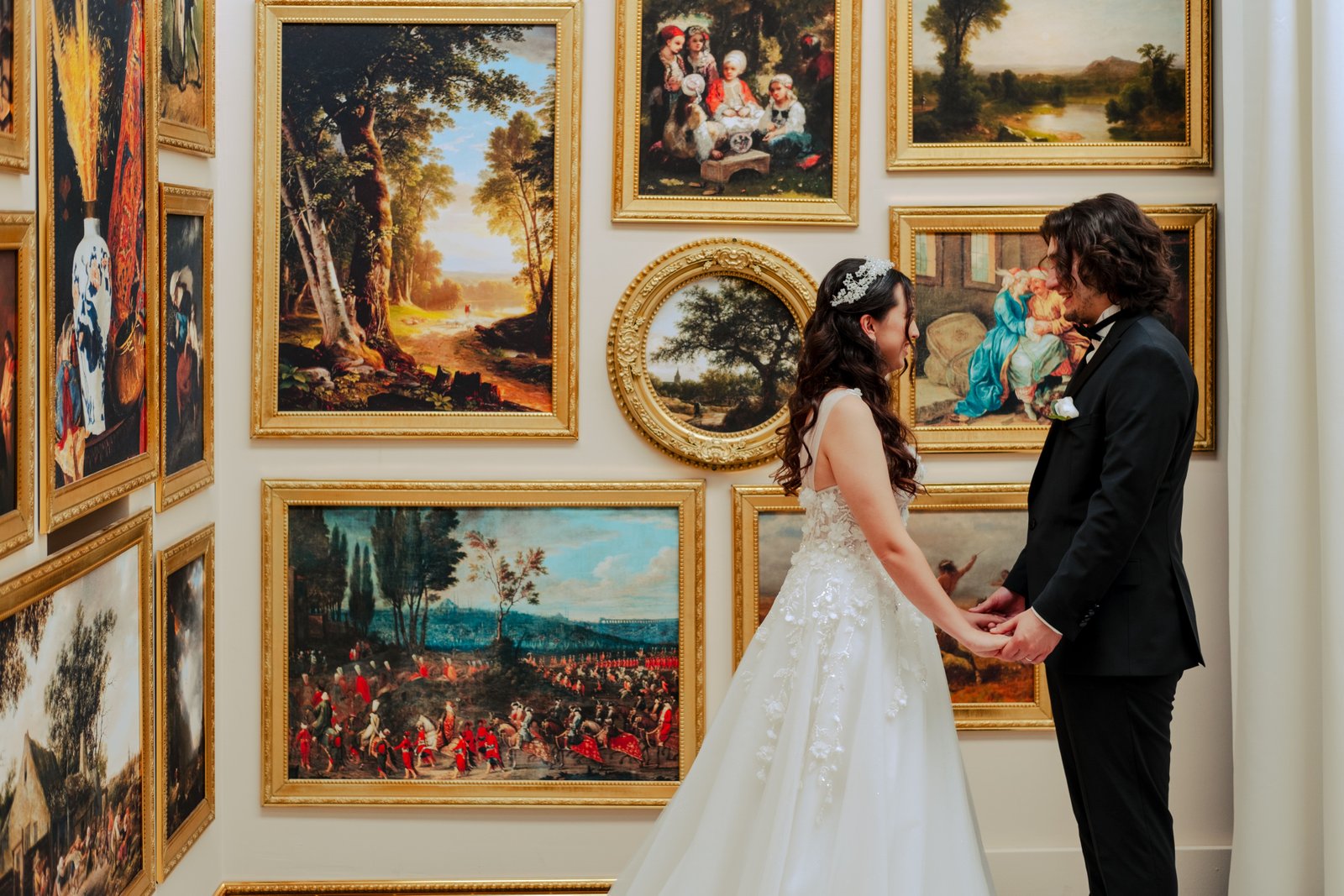 A bride poses in bridal hair and makeup near art gallery architecture at a Ringling Museum wedding.