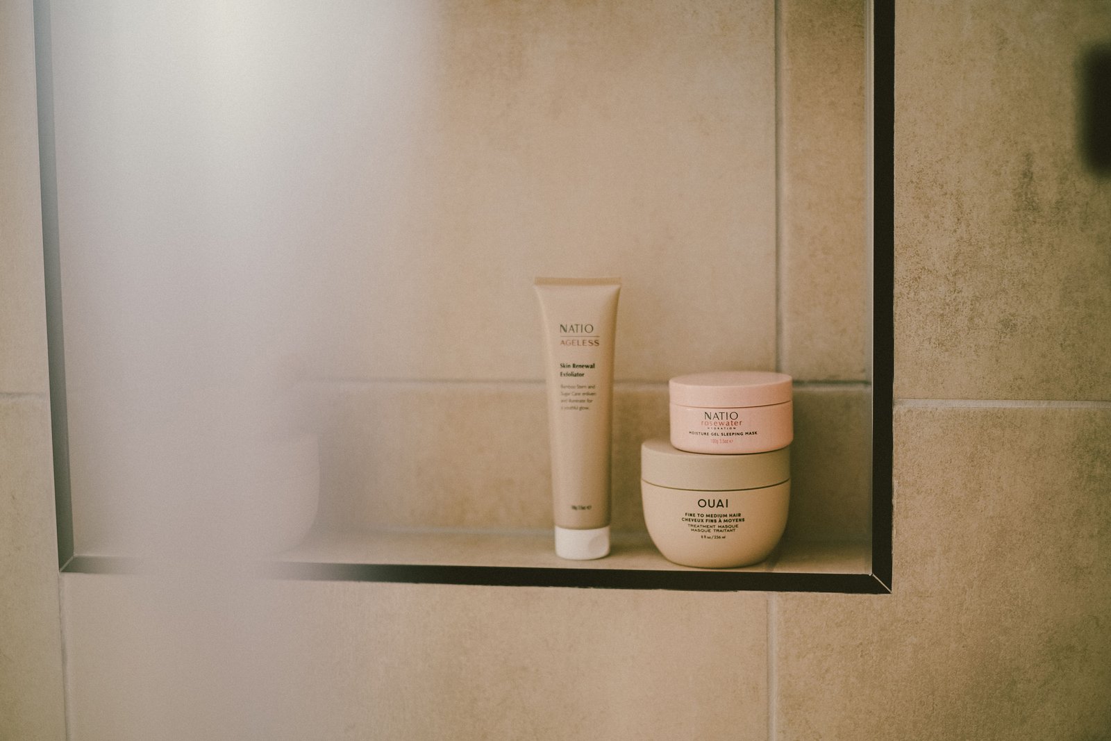 Modern bathroom shelf featuring hair care and beauty products