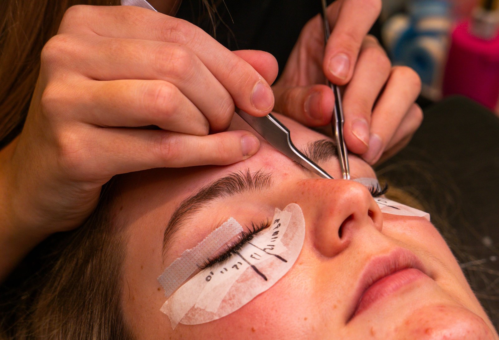 Close-up of volume eyelash extensions being applied to a client's eye