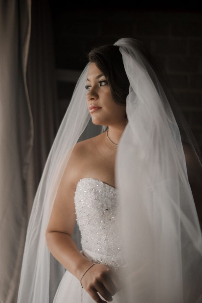 Bride by a window with a soft, natural flush like the Charlotte Tilbury heart blush creates