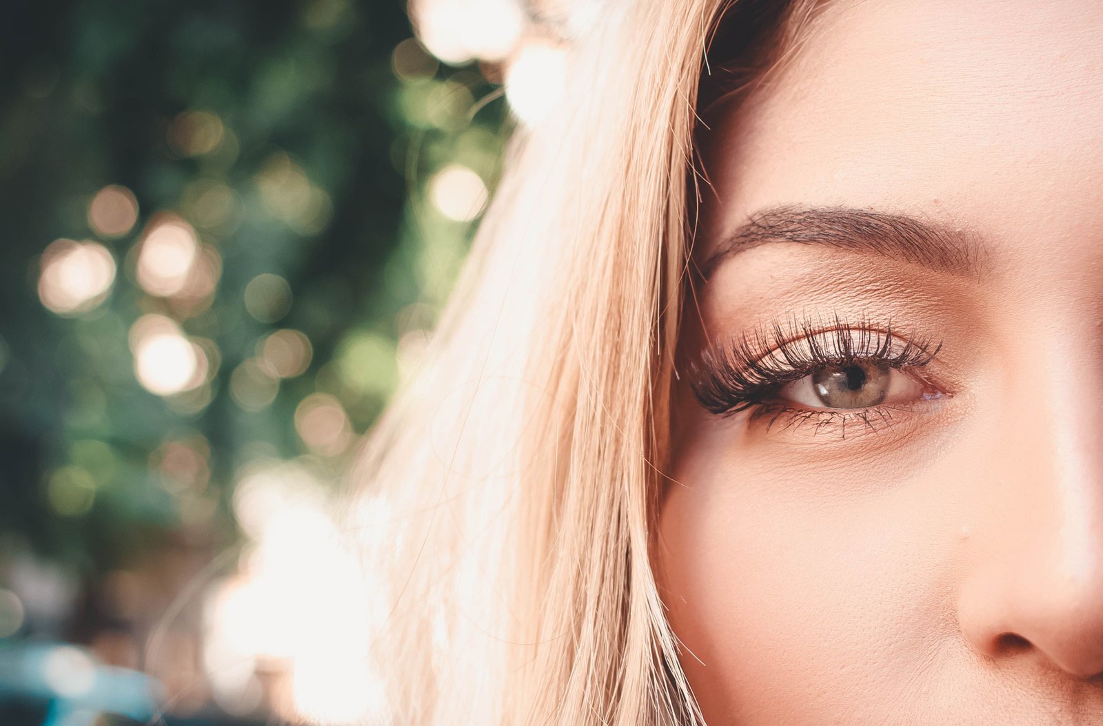Close-up of a woman's eye showcasing long, fluffy eyelash extensions