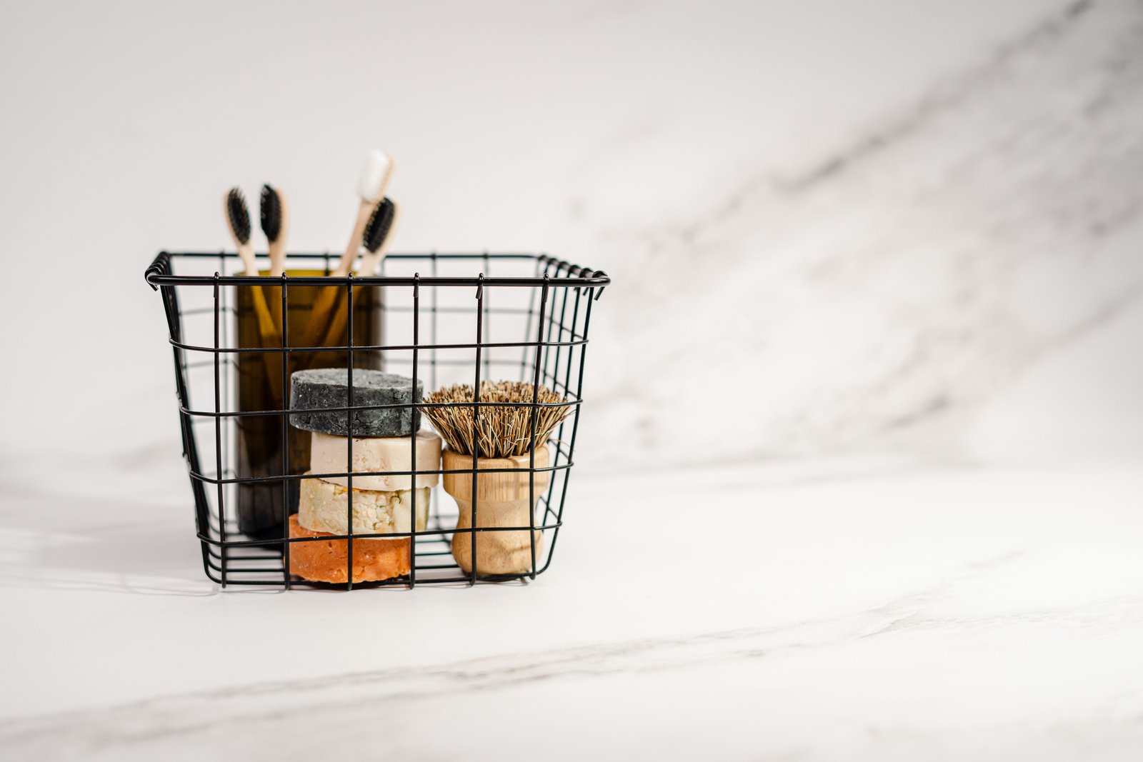 Minimalist beauty gift set arranged in a black wire basket