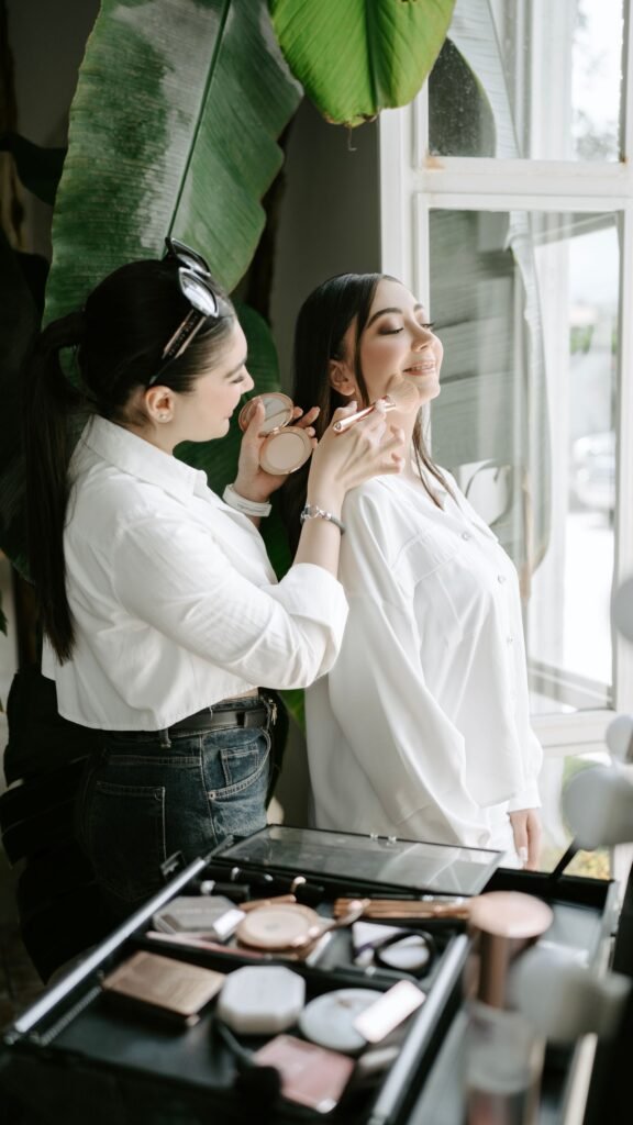 Makeup artist blotting and touching up a bride wearing Bobbi Brown Weightless Skin Foundation SPF 15 before photos