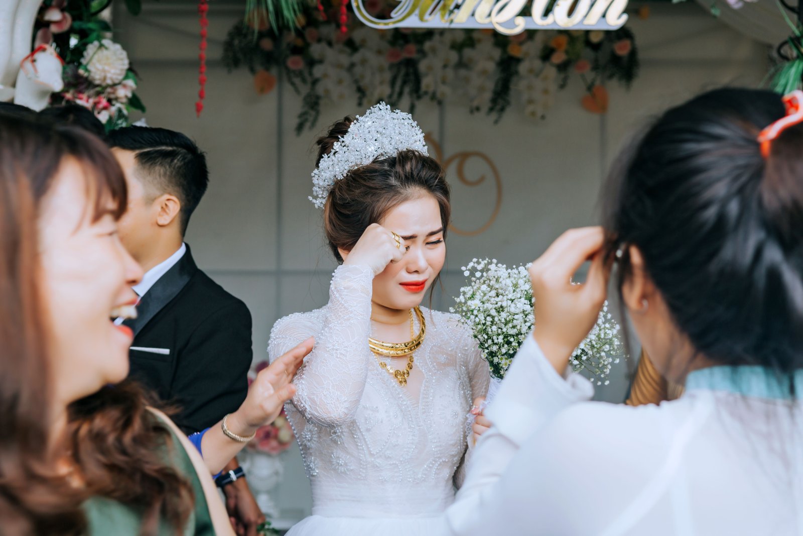 Bride with emotional tears during her wedding, makeup still holding through the moment