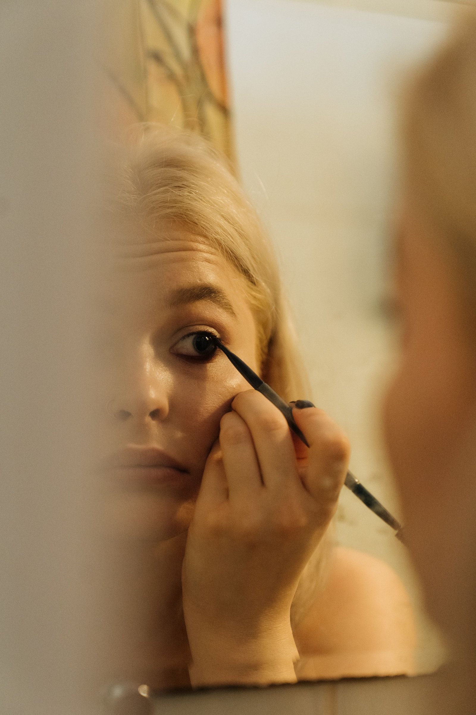 Fine brush applying water activated cake eyeliner for a precise line