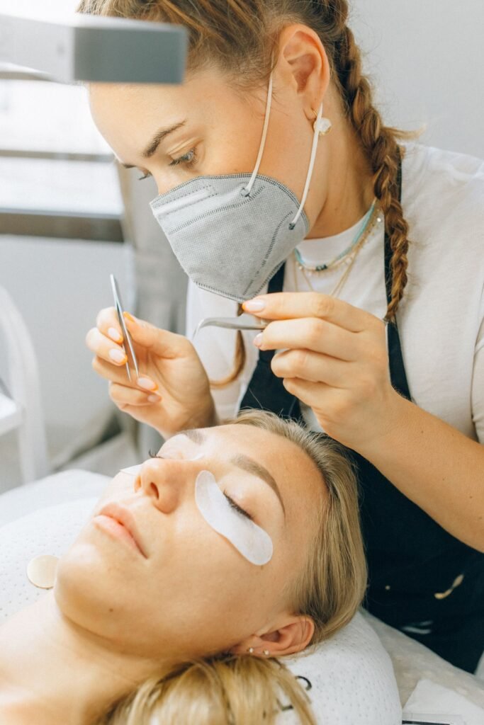 Lash technician carefully applying extensions using professional supplies like the B Lash range