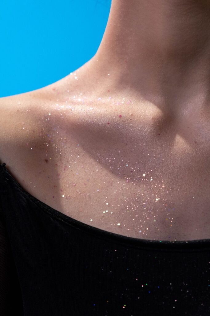 Cosmetic grade shimmer on a collarbone, a simple way to wear body paints for adults