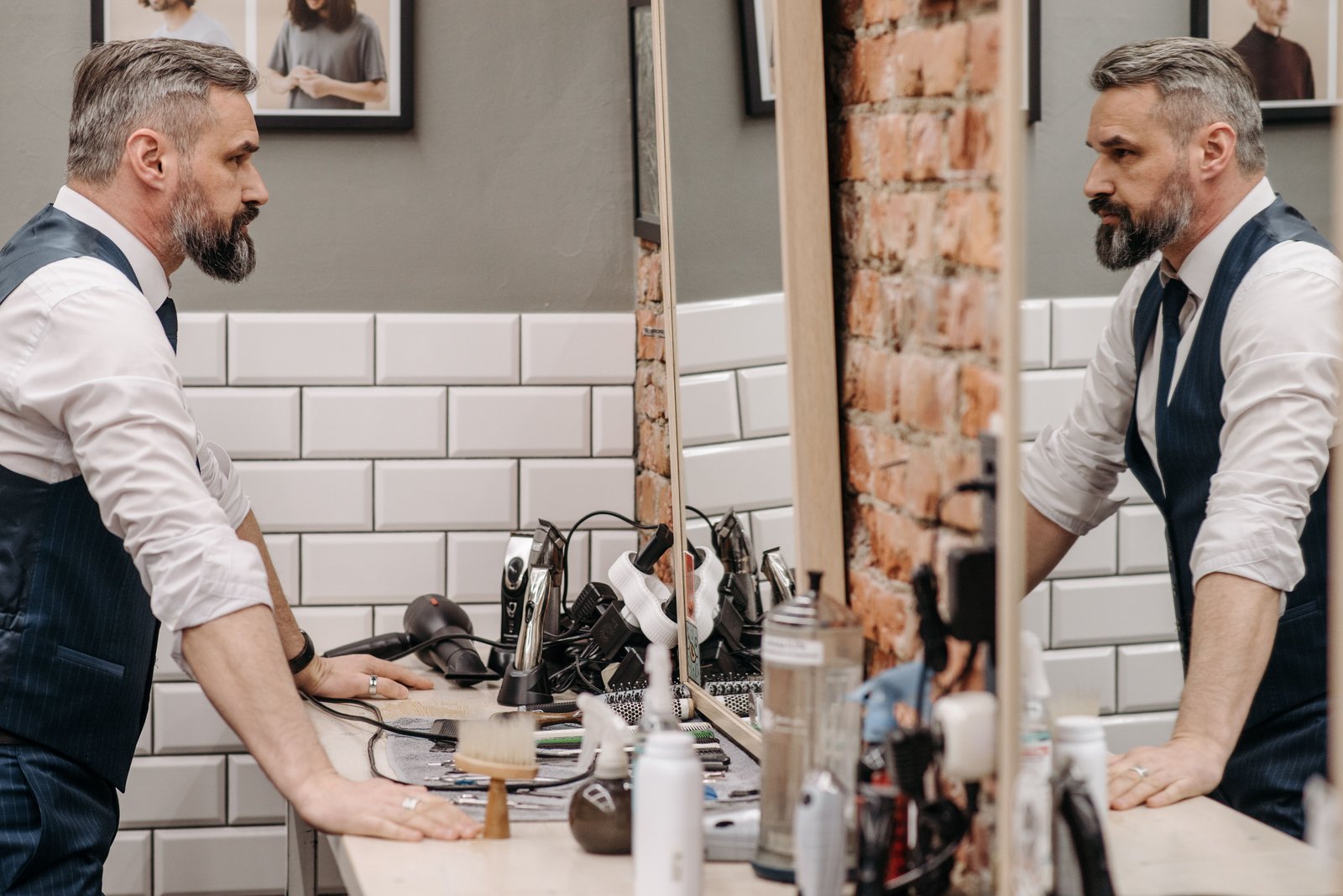 Man examining his hairstyle in a barbershop mirror