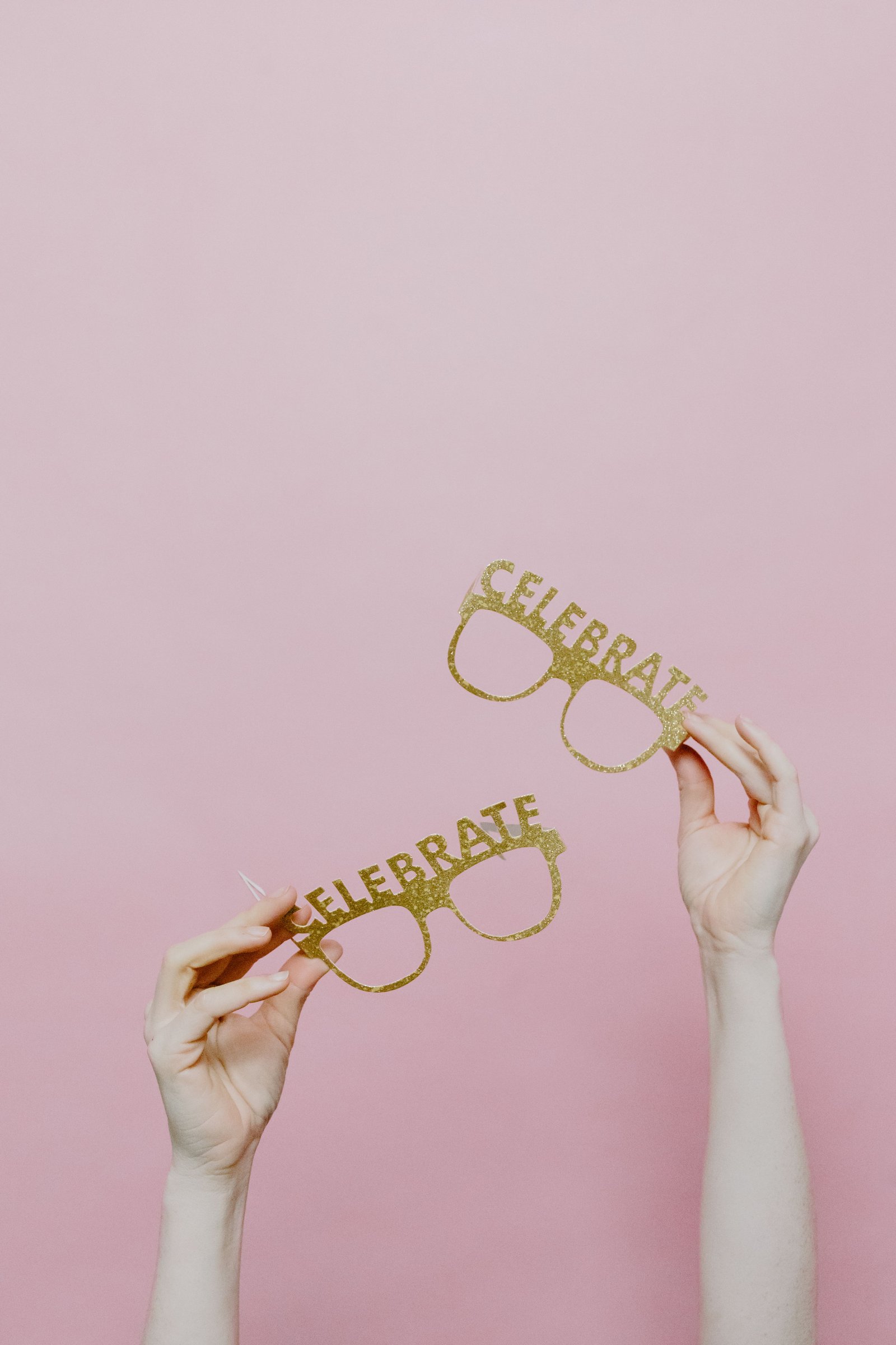 Wedding guests using fake mustaches in a fun photo moment