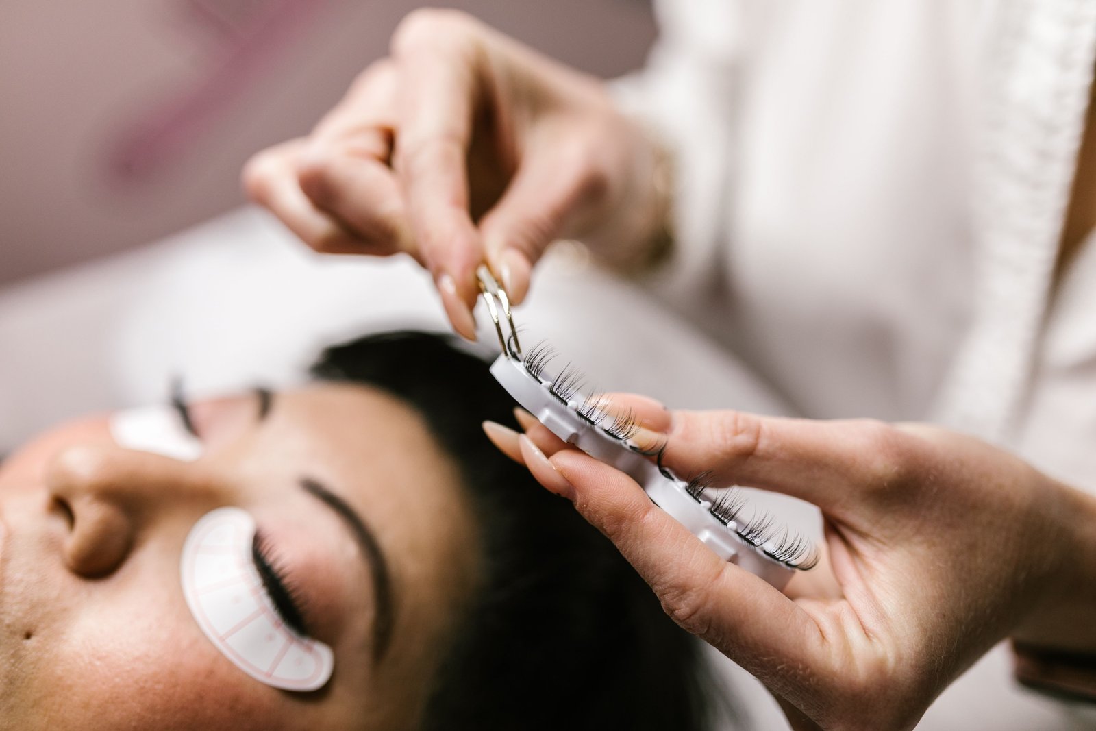 Detailed view of an eyelash extension procedure in a salon setting