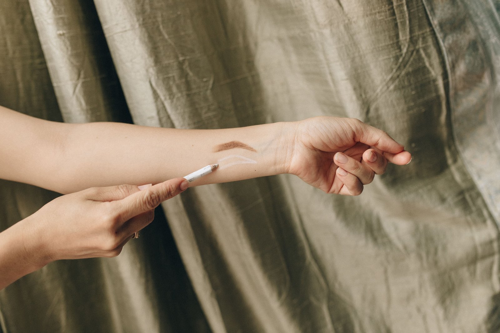 Foundation shade swatches tested along a forearm to check for an accurate color match