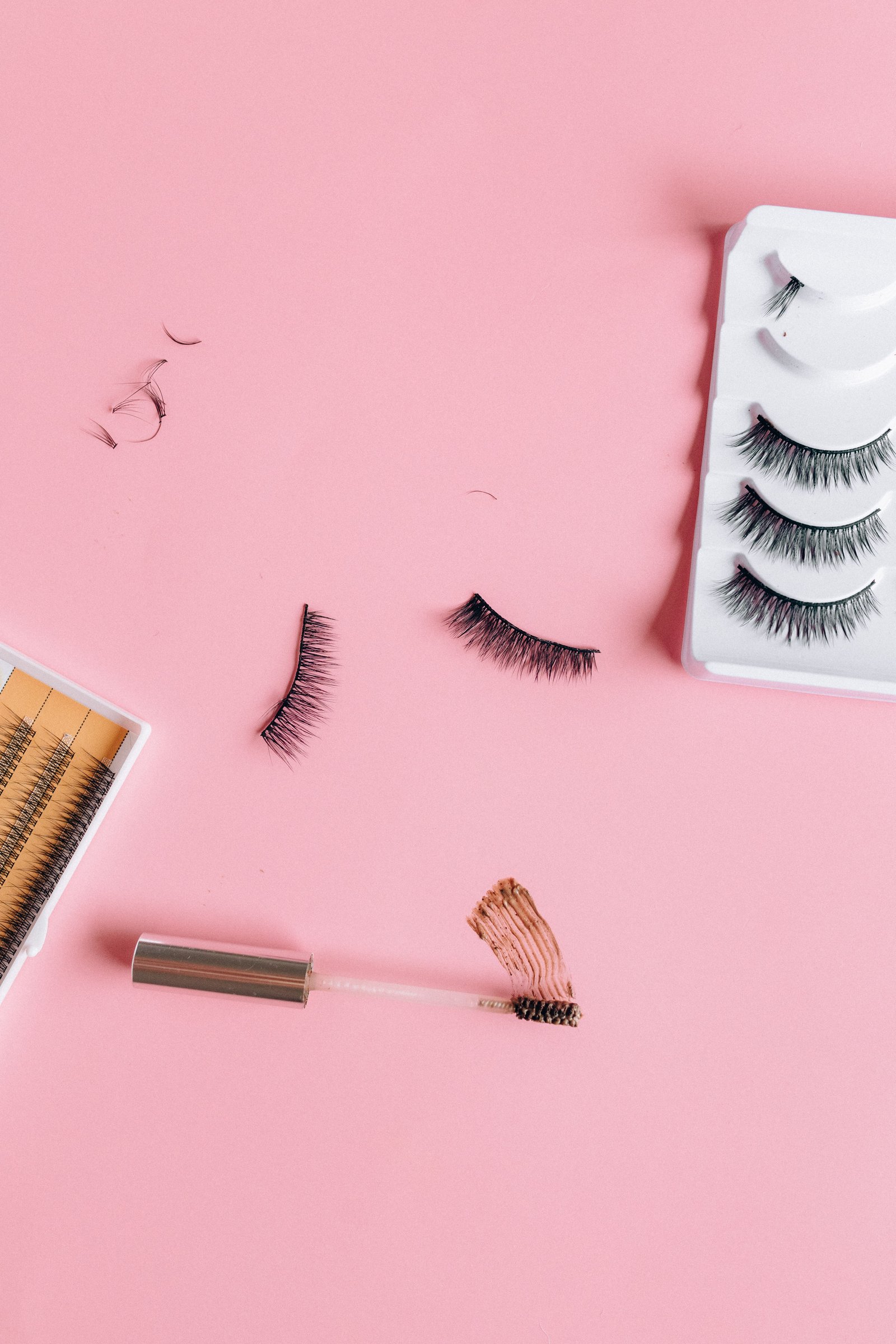 Ardell lash clusters and application tools laid out for a DIY application