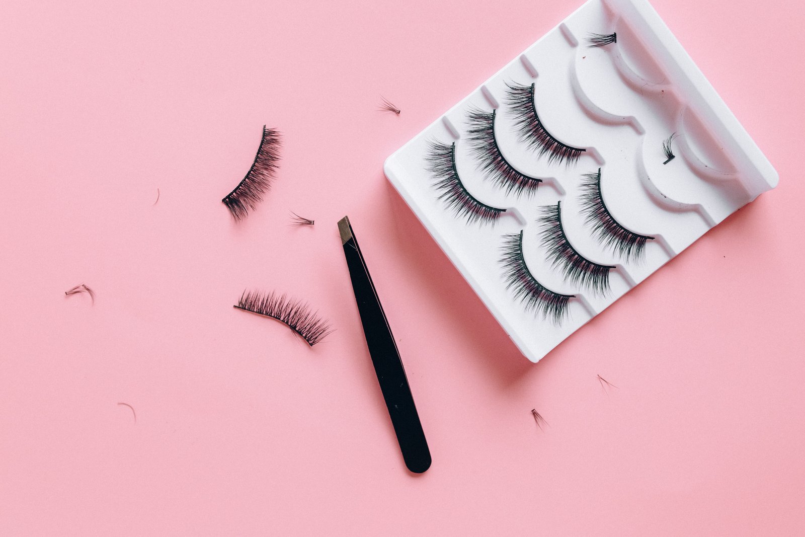 At-home lash extension kit flat lay with clusters and adhesive