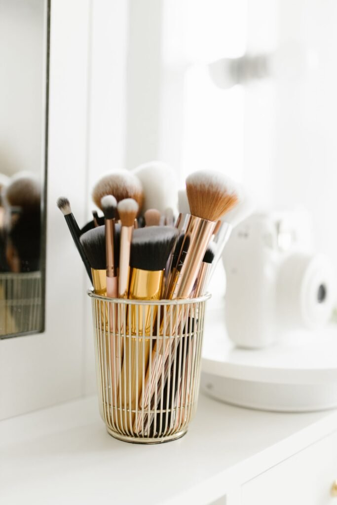 Organized makeup brushes in a holder on a vanity, the start of a simple home kit