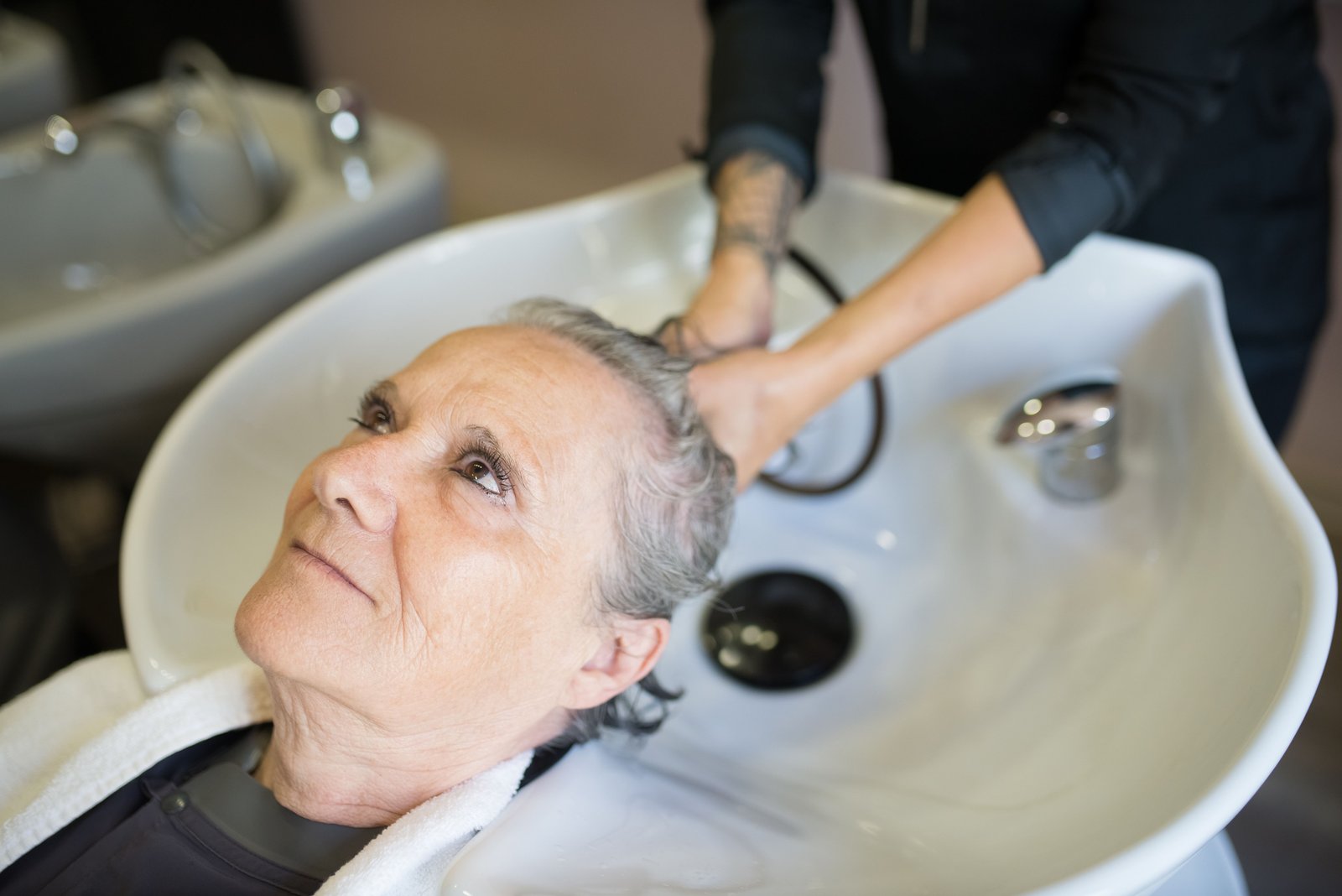 Client receiving a relaxing hair wash at a beauty salon