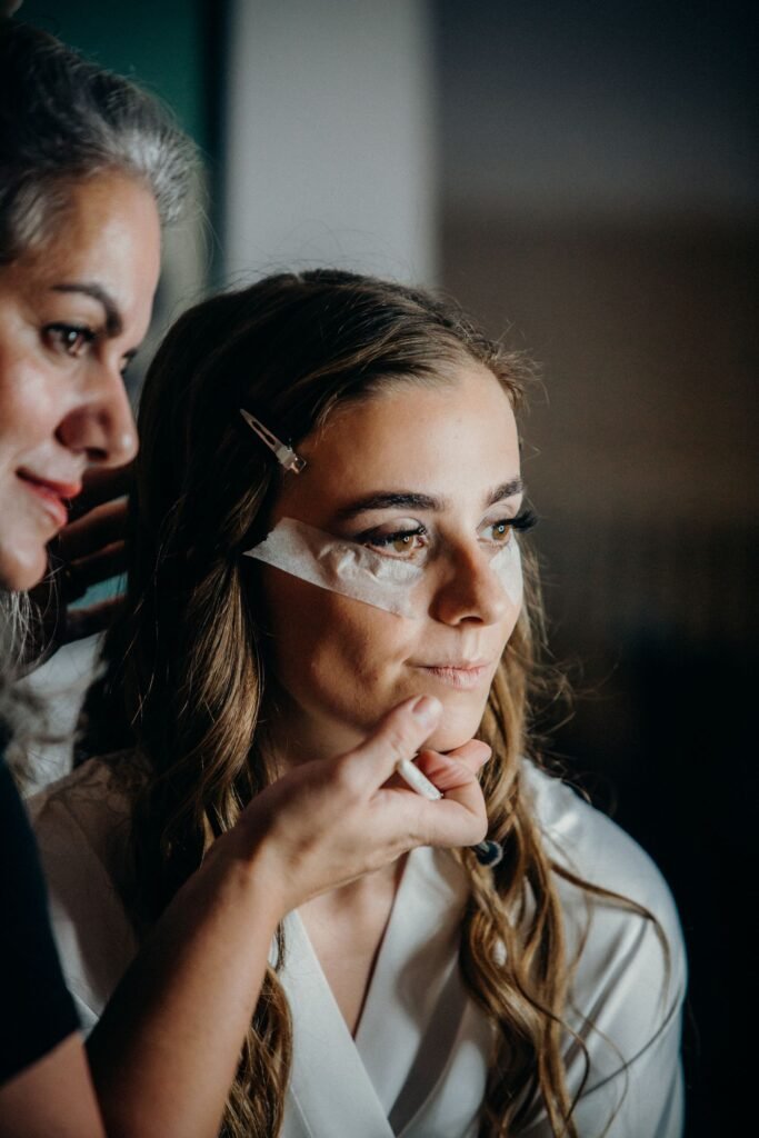 Bride with fresh lashes getting ready, showing how a good lash lounge experience fits into wedding prep